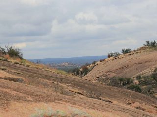 the pink granite rock that is Enchanted Rock State Park is one of the things to do in Fredericksburg, TX